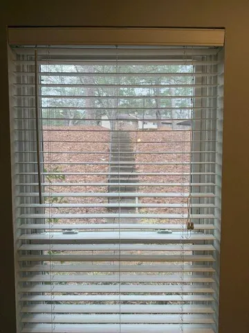 a living room with wooden floor and a window