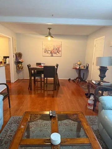 a hallway with a couch and wooden floor