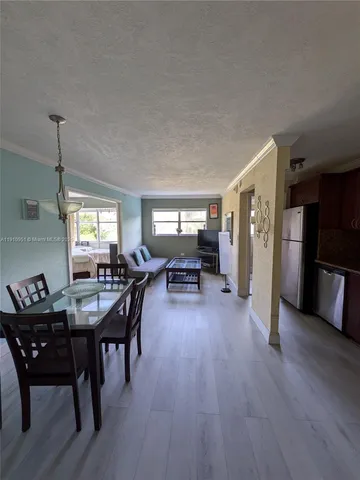 a dining room with furniture and wooden floor