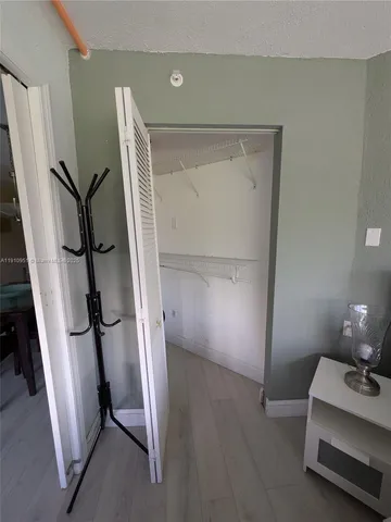 a view of an empty room and wooden floor