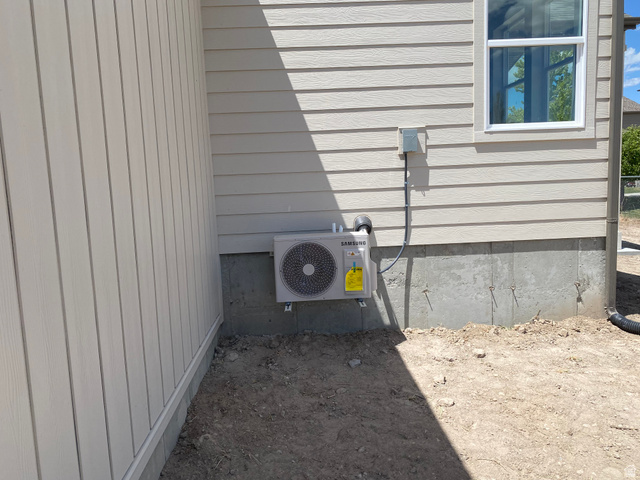 4676 West 75 North, Unit 401 West Point, UT 84015 - Photo 17 of 17 New exterior air conditioning unit installed on a concrete foundation