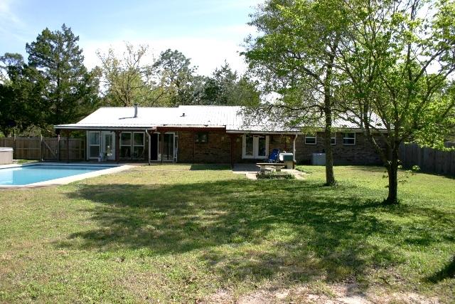 3559 Poverty Creek Road Crestview, FL 32539 - Photo 27 of 34 a swimming pool with outdoor seating and yard