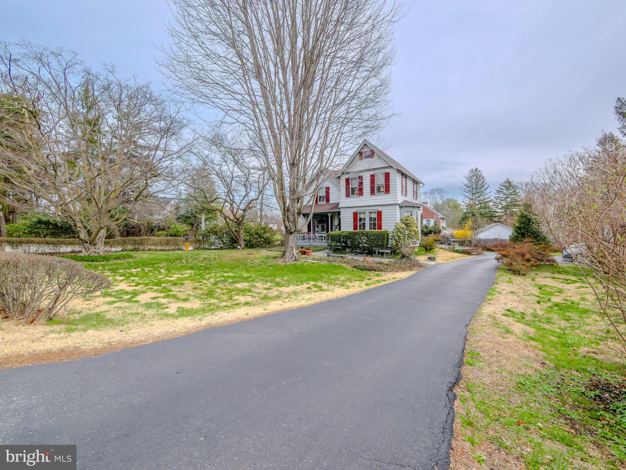 a view of house with yard and green space