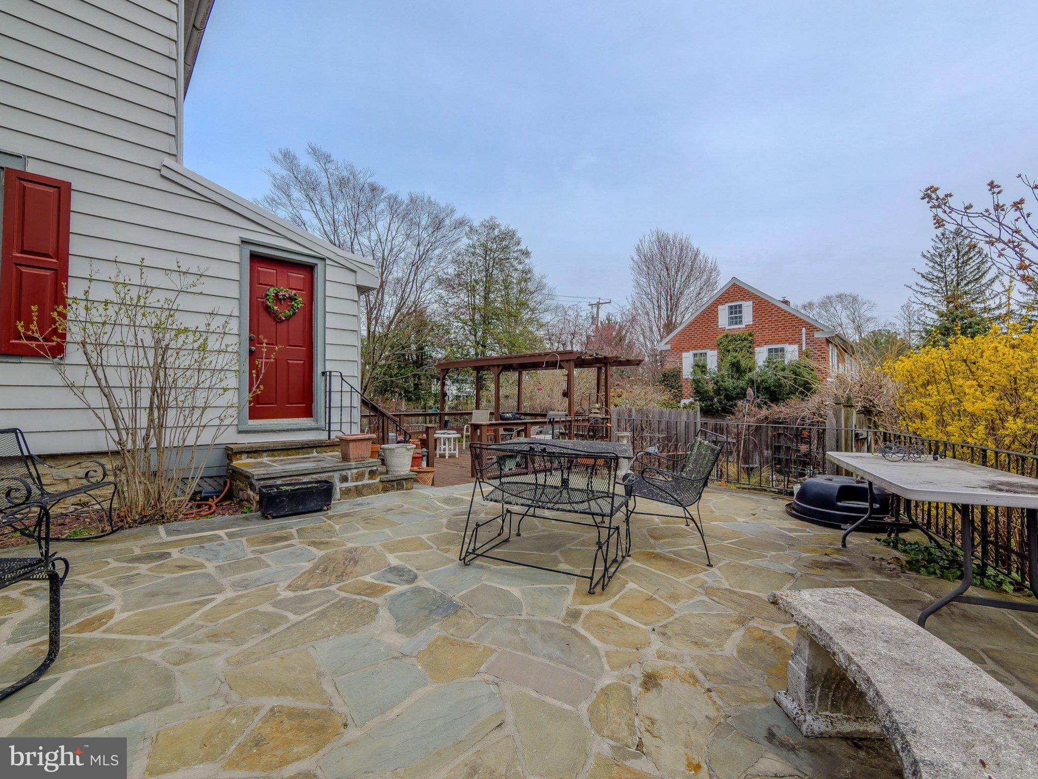 332 North Providence Road Wallingford, PA 19086 - Photo 45 of 48 a view of a patio with a table and chairs and potted plants