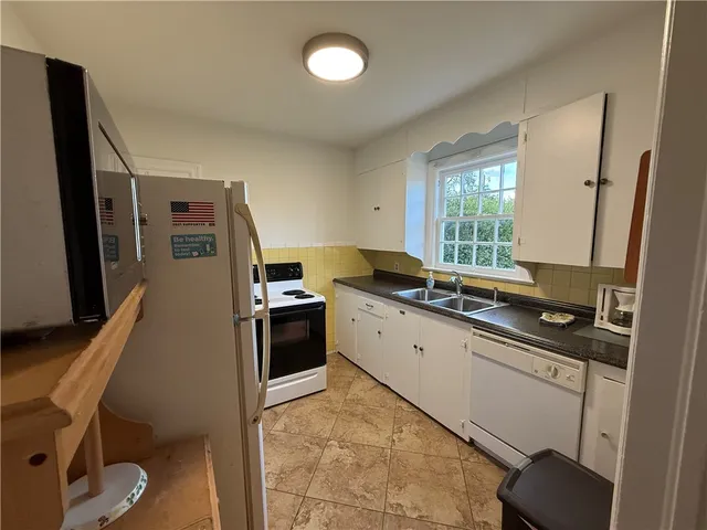 a kitchen with a sink appliances and cabinets