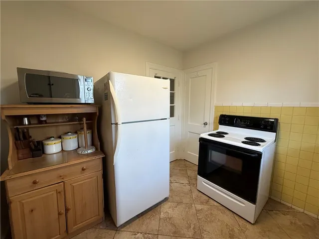 a kitchen with stainless steel appliances granite countertop a refrigerator stove and microwave