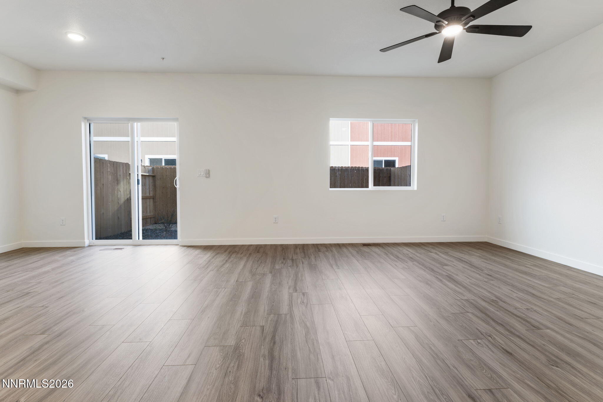 357 Halite Drive Dayton, NV 89403 - Photo 2 of 20 an empty room with wooden floor and windows