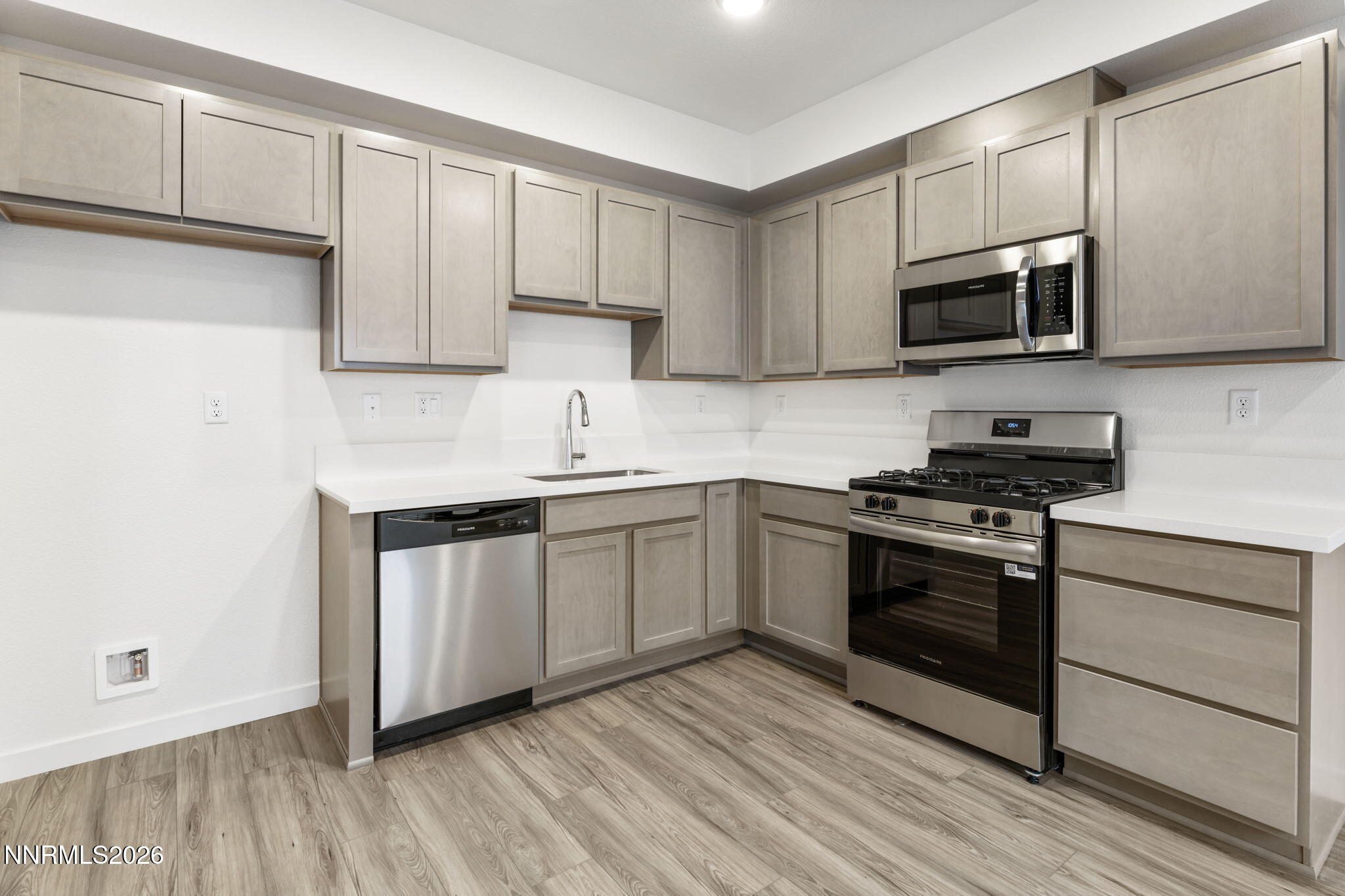 357 Halite Drive Dayton, NV 89403 - Photo 3 of 20 a kitchen with stainless steel appliances granite countertop a stove a sink and a microwave