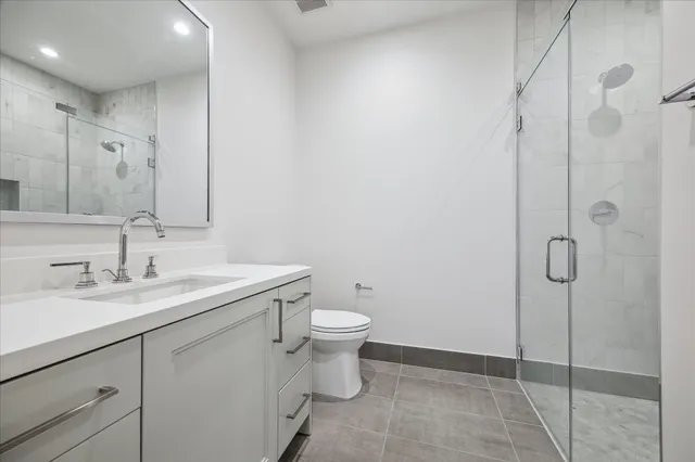 a view of an empty room with wooden floor and cabinet