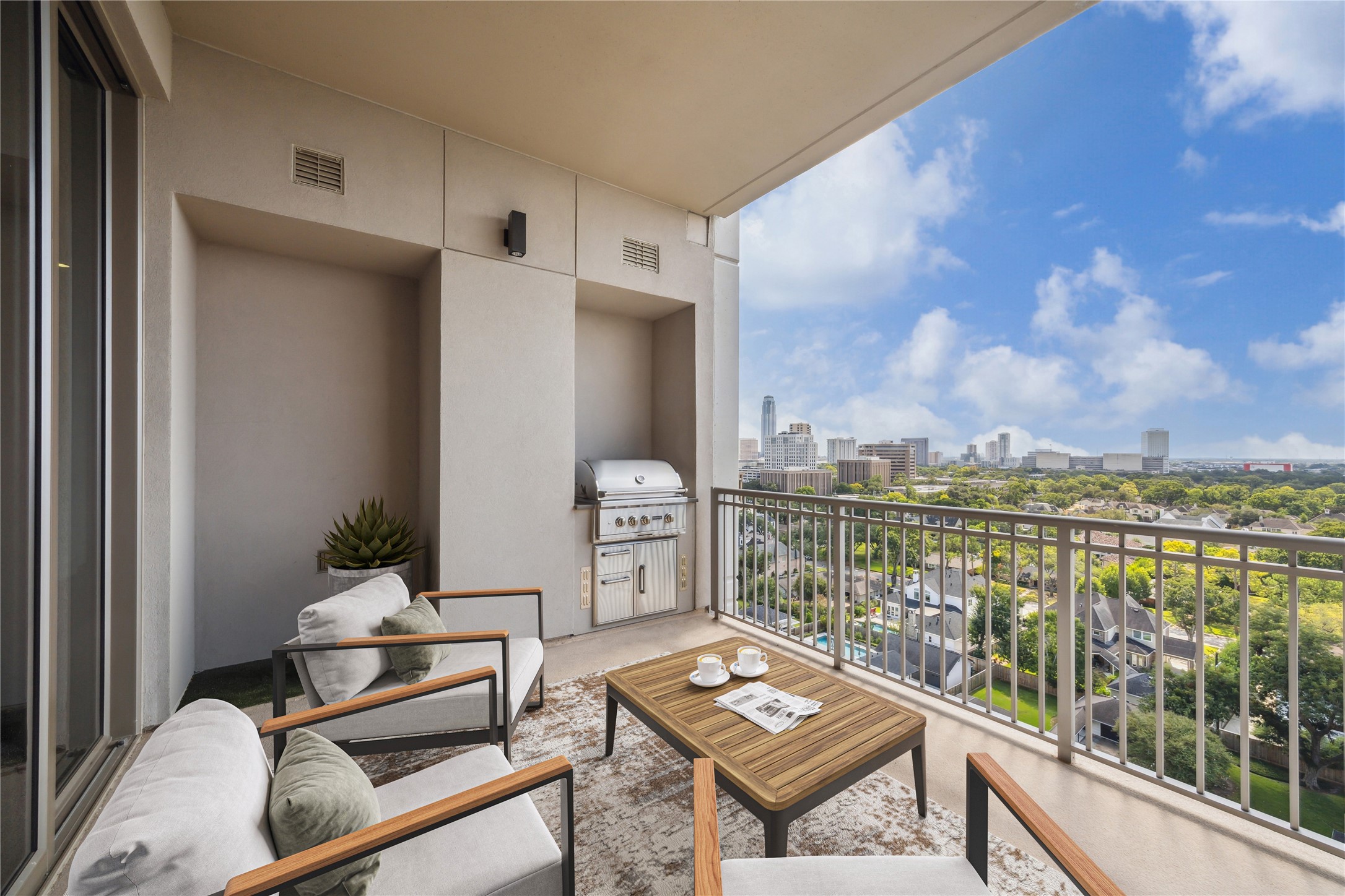 5656 San Felipe Street, Unit 1203 Houston, TX 77056 - Photo 8 of 22 a view of a balcony with chairs and wooden floor