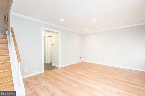 a big room with wooden floor and sliding door