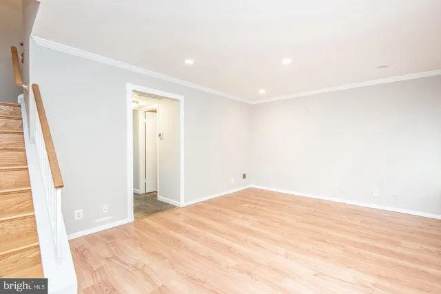 a big room with wooden floor and sliding door