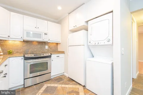 a kitchen with a white cabinets and white appliances