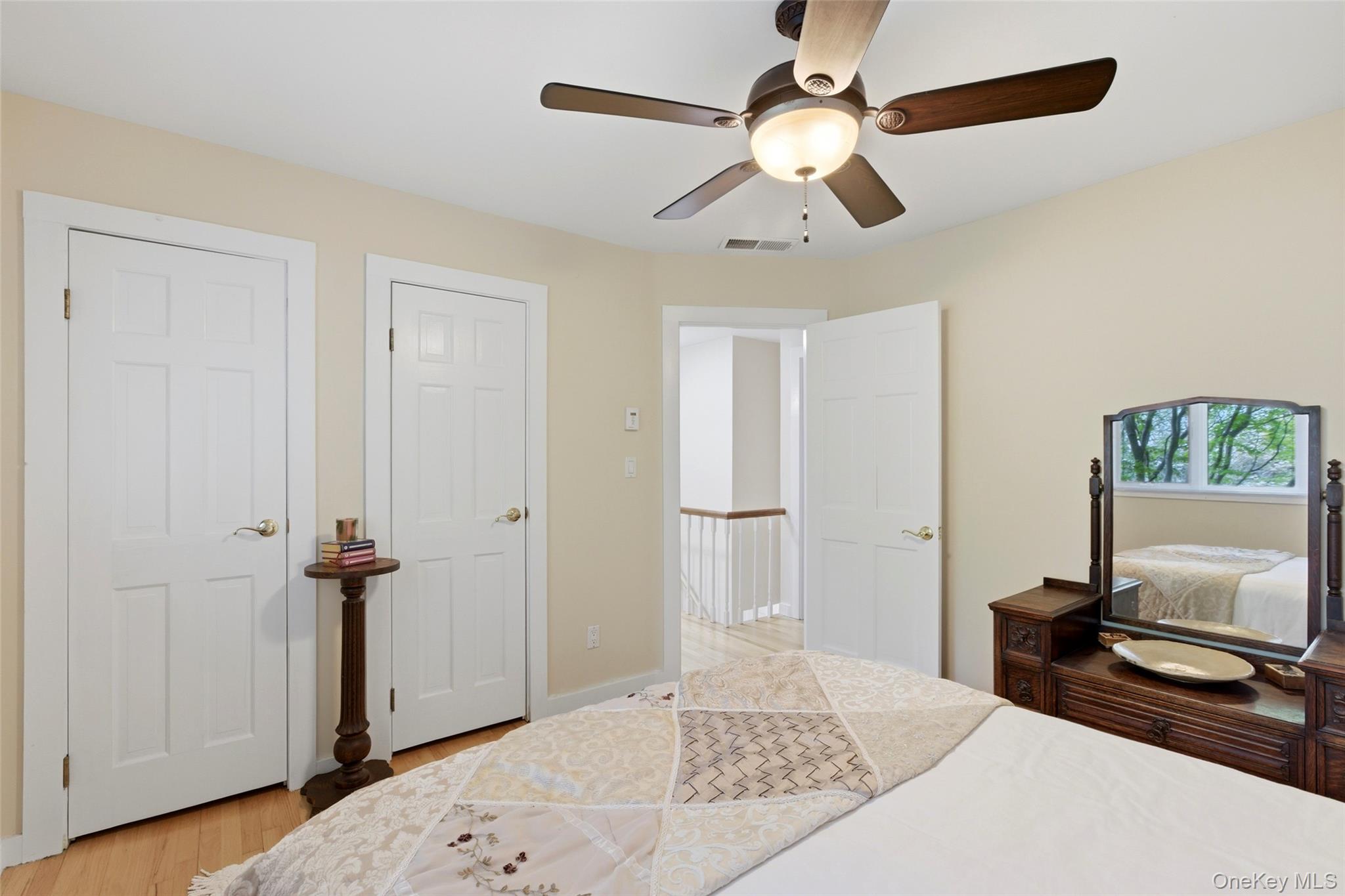 7 Gun Path Setauket, NY 11733 - Photo 22 of 34 a bedroom with a bed and a chandelier