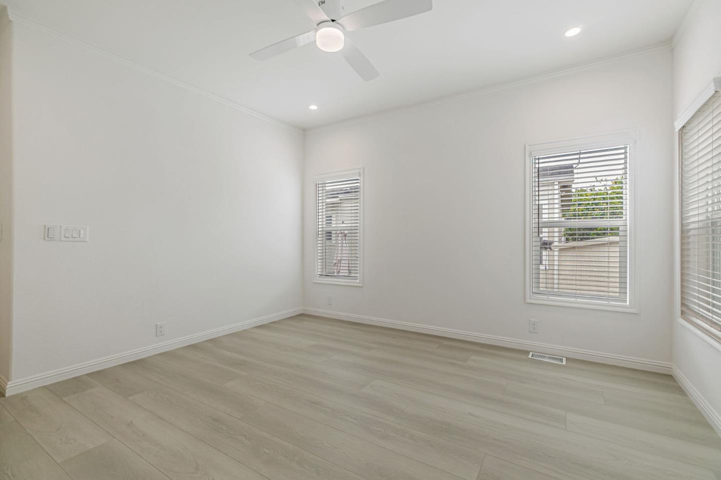555 Umbarger Road, Unit 131 San Jose, CA 95111 - Photo 21 of 32 an empty room with wooden floor and windows