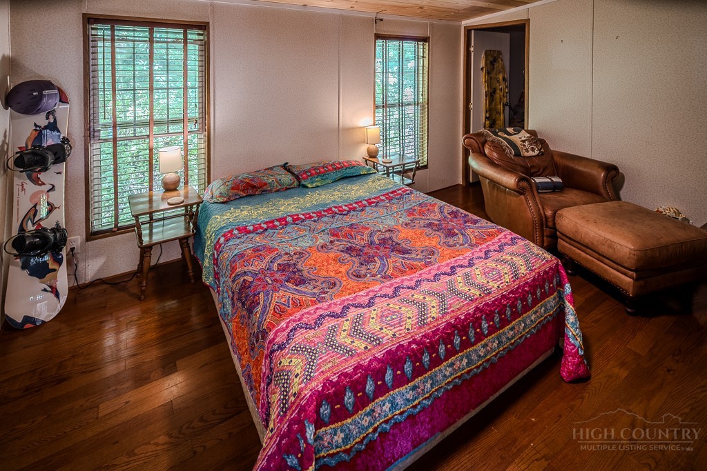 461 Reuben Wooten Road Banner Elk, NC 28604 - Photo 20 of 39 a bedroom with a bed and wooden floor