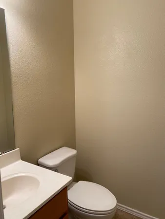 a white toilet sitting next to a white sink