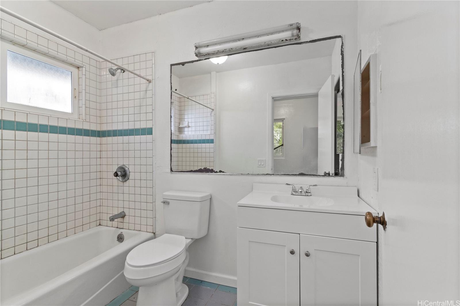 54-230 Hauula Homestead Road, Unit A Hauula, HI 96717 - Photo 19 of 22 a bathroom with a sink toilet vanity and shower