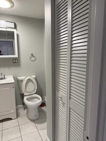 a bathroom with a toilet a sink and mirror