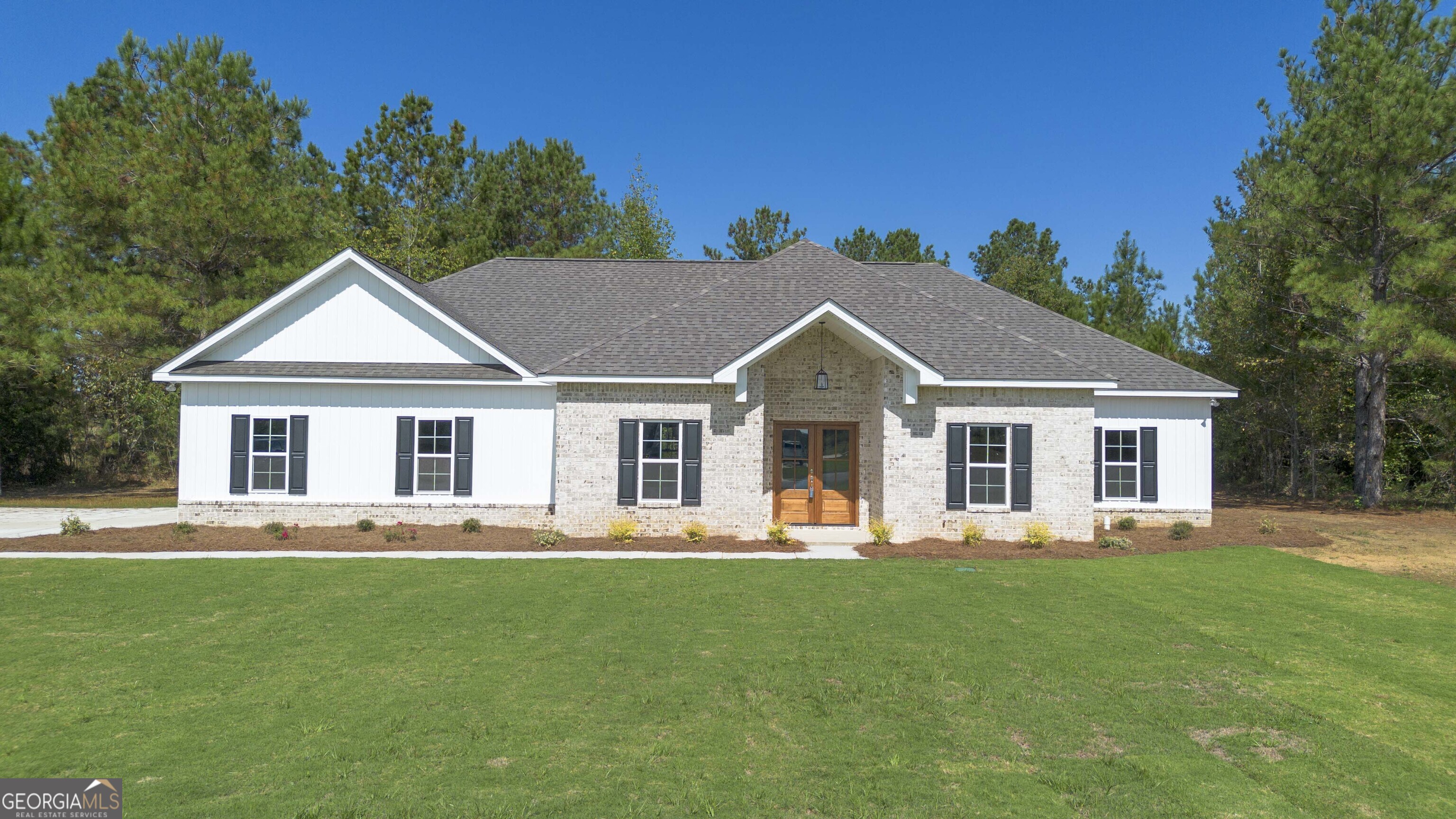 639 Jones Road Cochran, GA 31014 - Photo 1 of 1 a front view of a house with a yard table and chairs