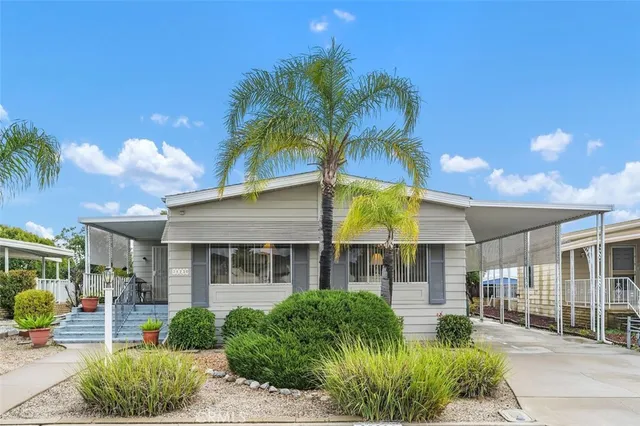a front view of a house with garden and porch