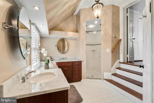 a bathroom with a sink vanity and a mirror