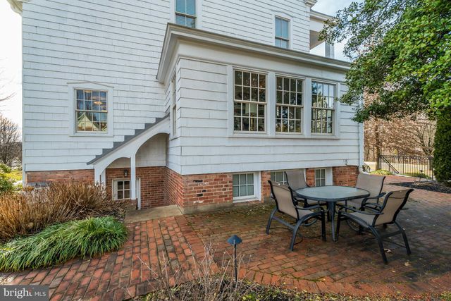 a view of a house with a backyard and sitting area