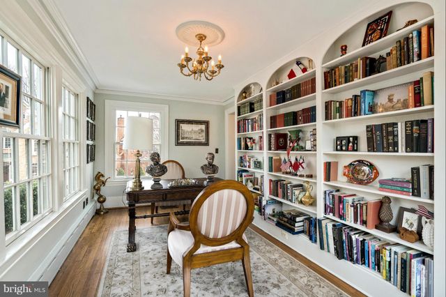 a living room with lots of furniture and a book shelf