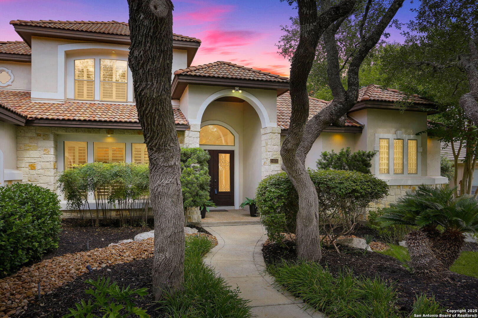 a front view of a house with garden