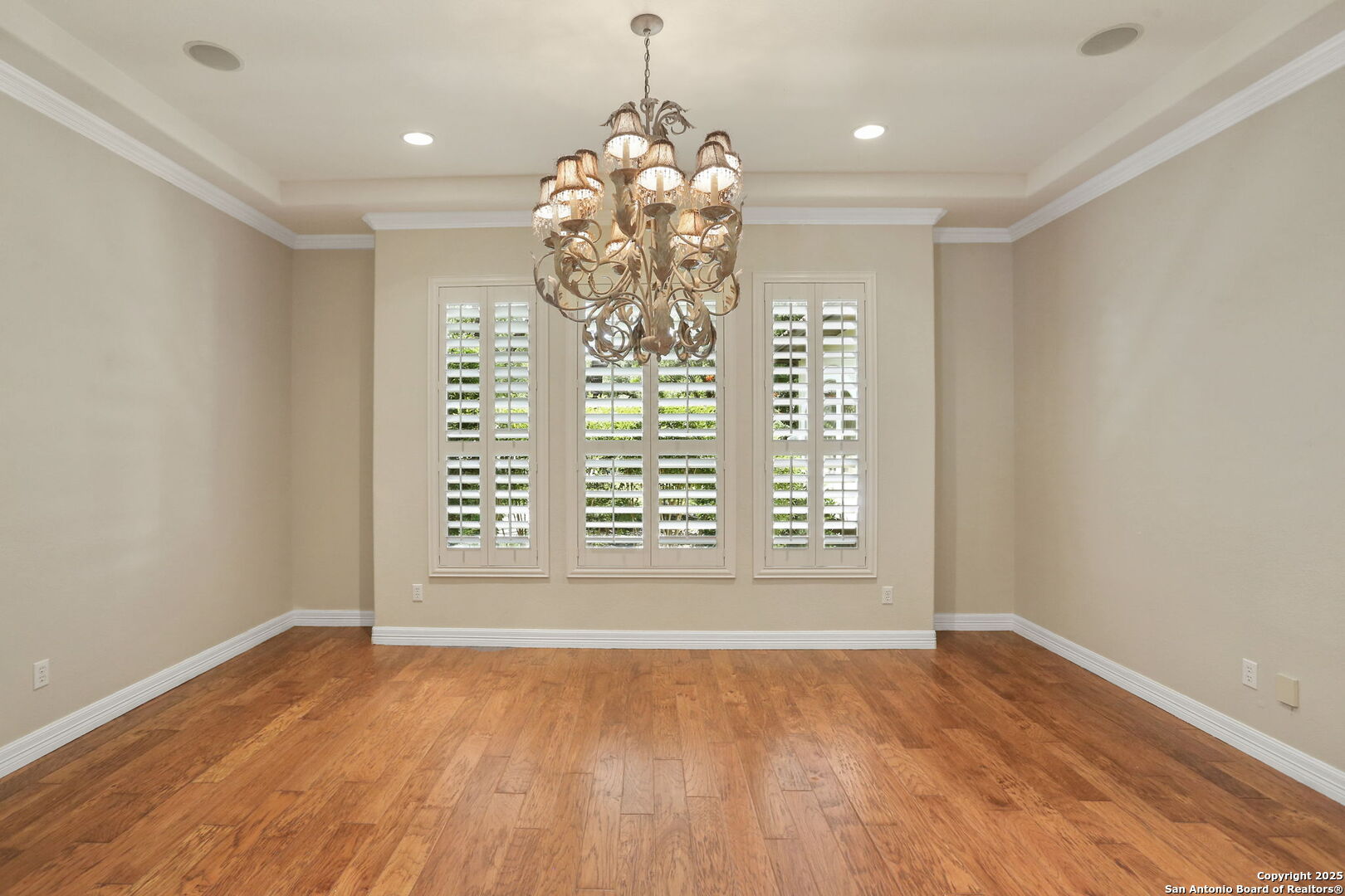 24630 Bogey Ridge San Antonio, TX 78260 - Photo 13 of 50 a view of an empty room with wooden floor and a window