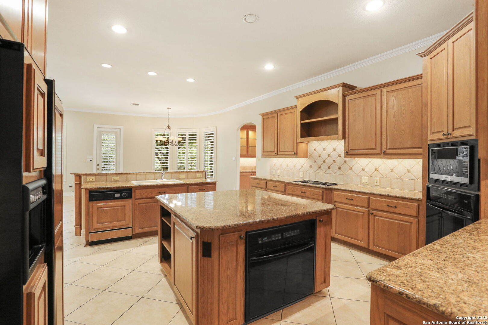 24630 Bogey Ridge San Antonio, TX 78260 - Photo 20 of 50 a kitchen with stainless steel appliances granite countertop a stove a sink and a refrigerator