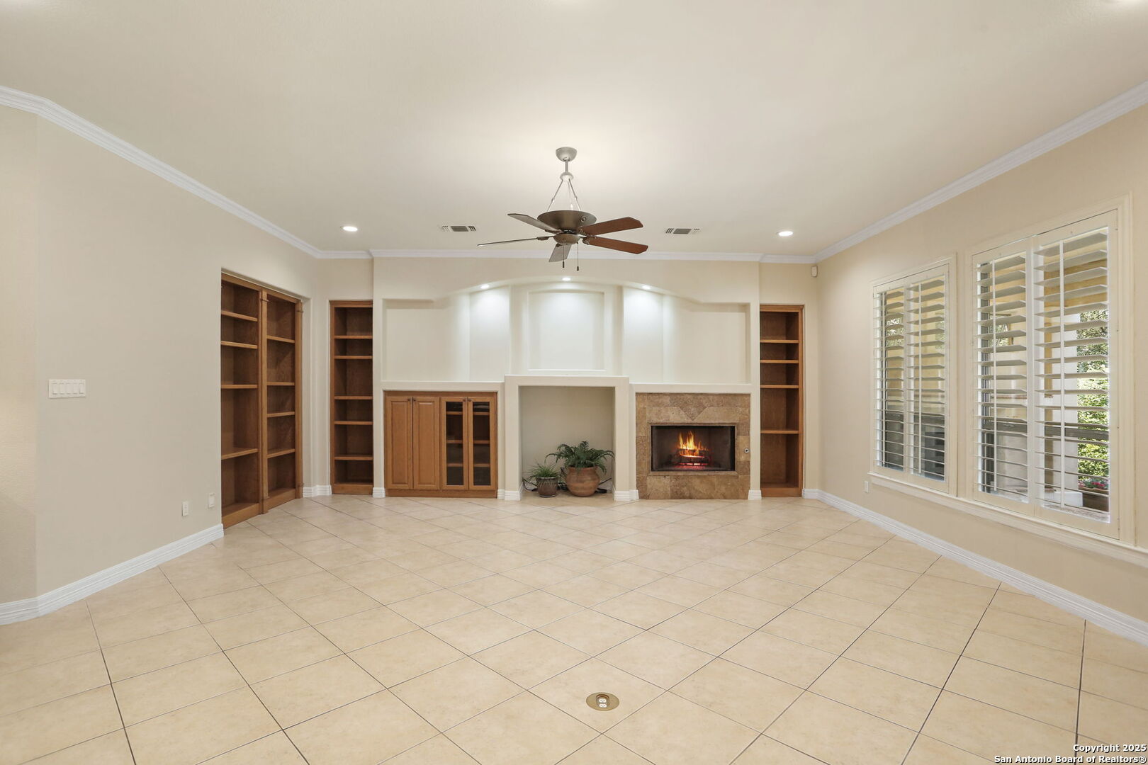 24630 Bogey Ridge San Antonio, TX 78260 - Photo 22 of 50 an empty room with fireplace windows and cabinet