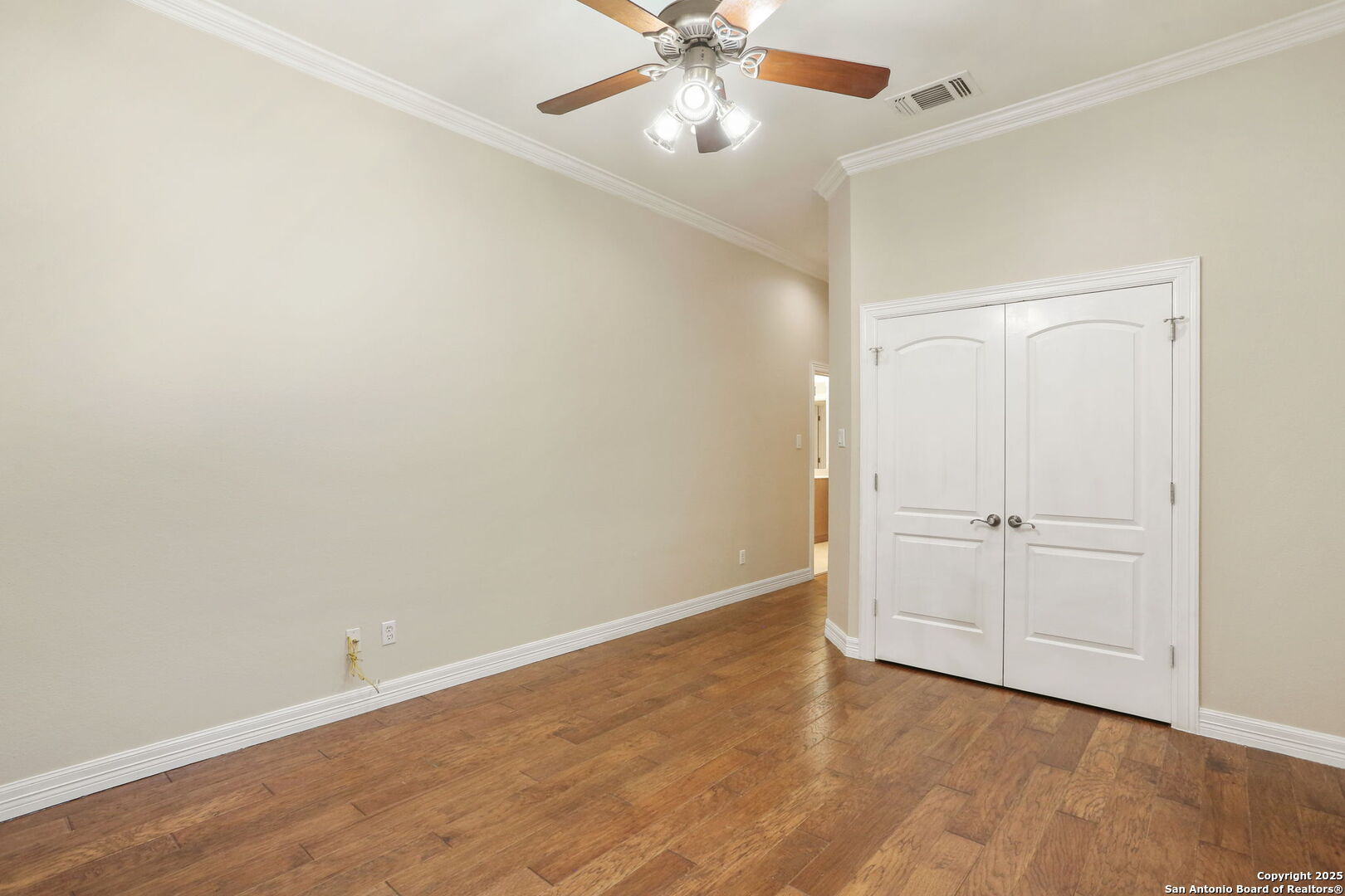 24630 Bogey Ridge San Antonio, TX 78260 - Photo 28 of 50 an empty room with a ceiling fan and wooden floor