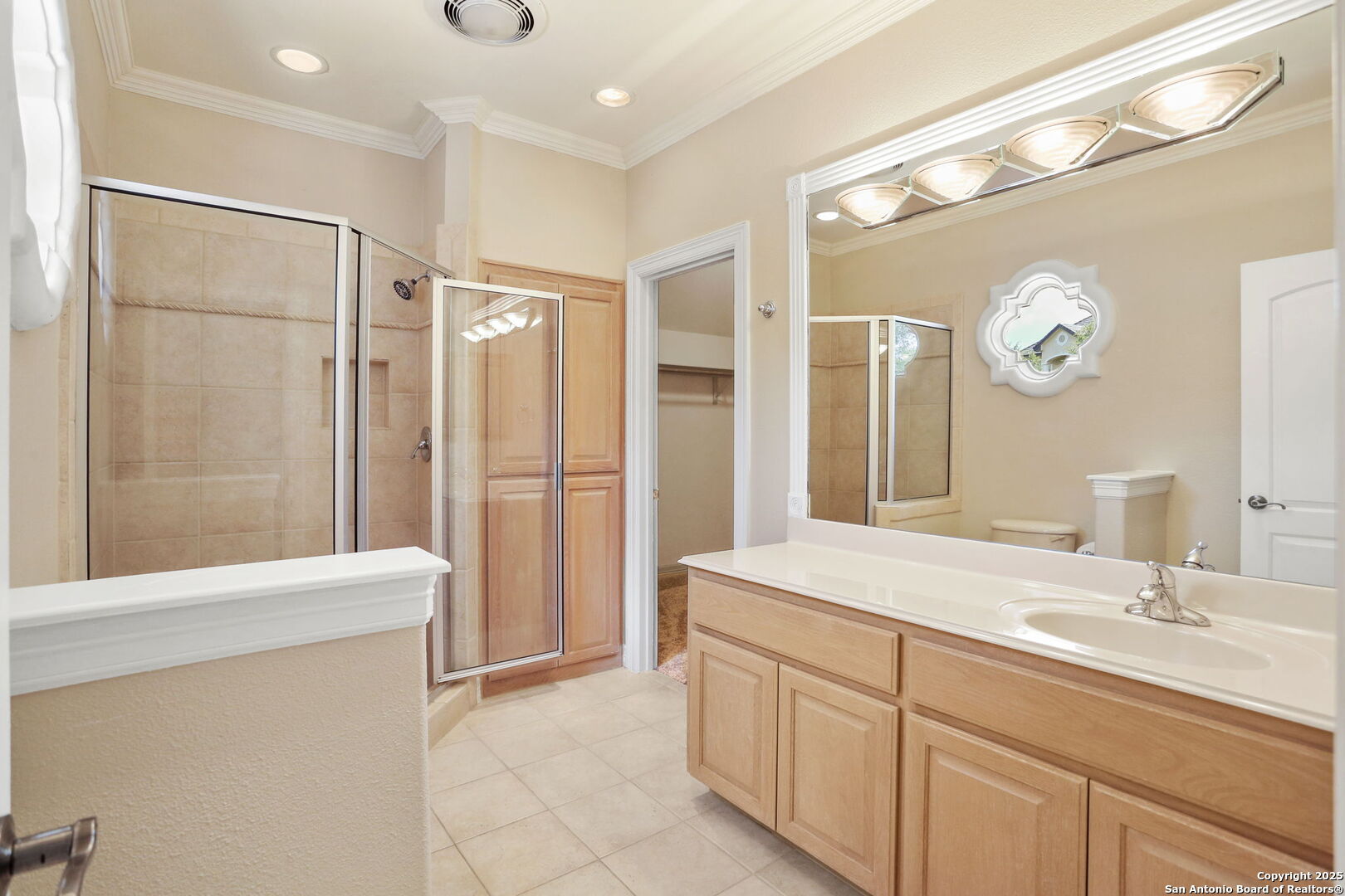 24630 Bogey Ridge San Antonio, TX 78260 - Photo 40 of 50 a spacious bathroom with a shower a sink and a mirror