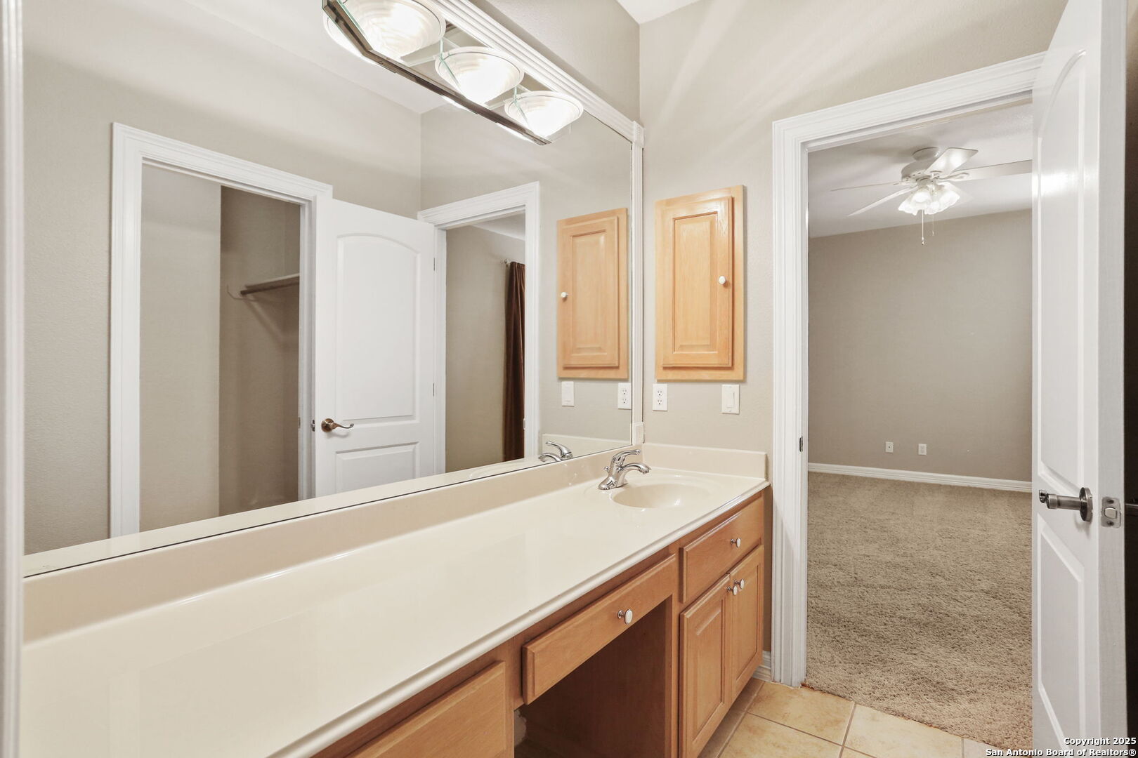 24630 Bogey Ridge San Antonio, TX 78260 - Photo 43 of 50 a bathroom with a double vanity sink and mirror