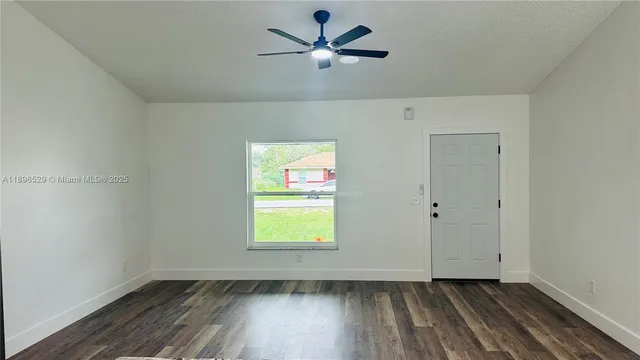 a view of room with a ceiling fan and window