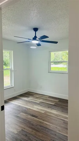 a view of room with window and ceiling fan