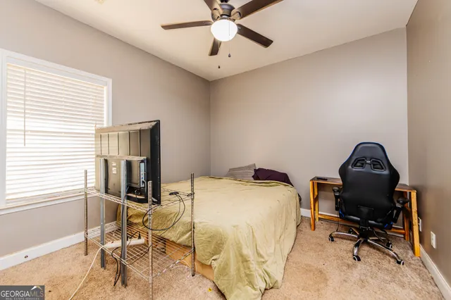 a bathroom with a granite countertop toilet sink and mirror