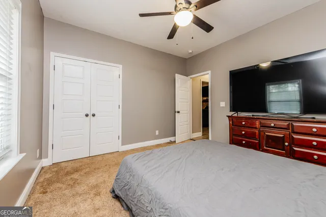 a bathroom with a granite countertop sink toilet and mirror