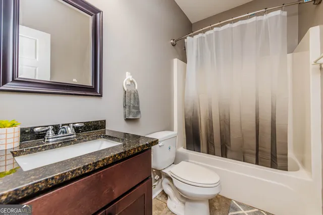 a bedroom with a bed and a ceiling fan