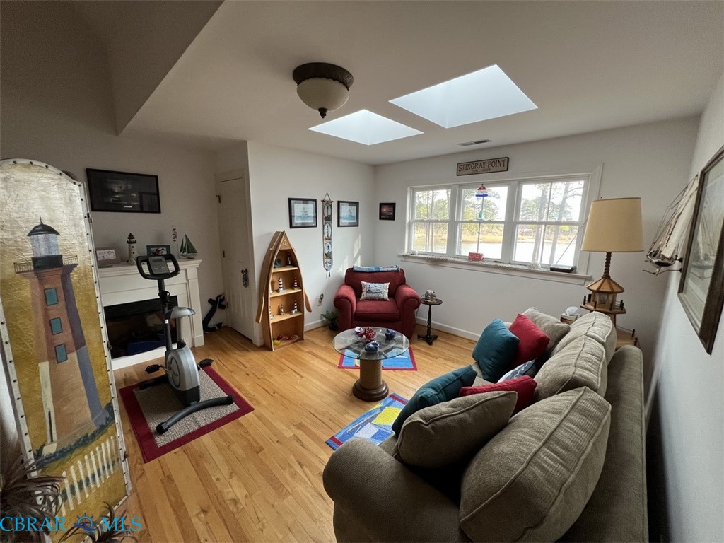 301 Gillim Road Deltaville, VA 23043 - Photo 20 of 31 Workout room featuring light wood-style floors and a skylight