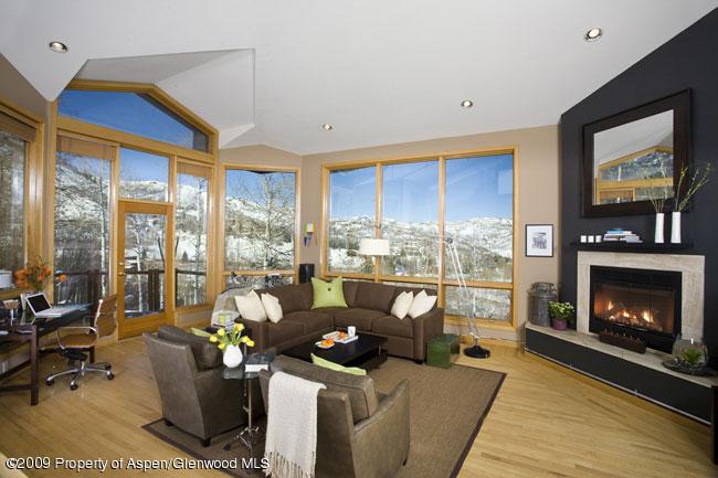 135 North Ridge Lane Snowmass Village, CO 81615 - Photo 1 of 8 a living room with furniture large window and a fireplace