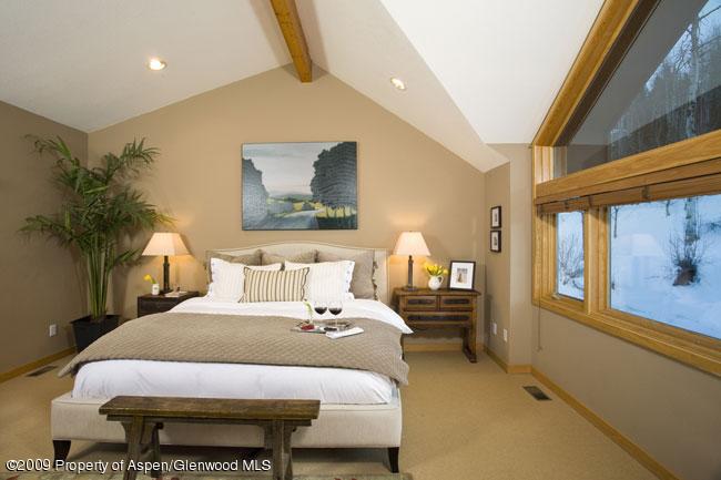 135 North Ridge Lane Snowmass Village, CO 81615 - Photo 2 of 8 a bedroom with a bed and a painting on the wall