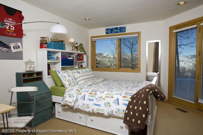 135 North Ridge Lane Snowmass Village, CO 81615 - Photo 5 of 8 a bedroom with a bed and wooden floor
