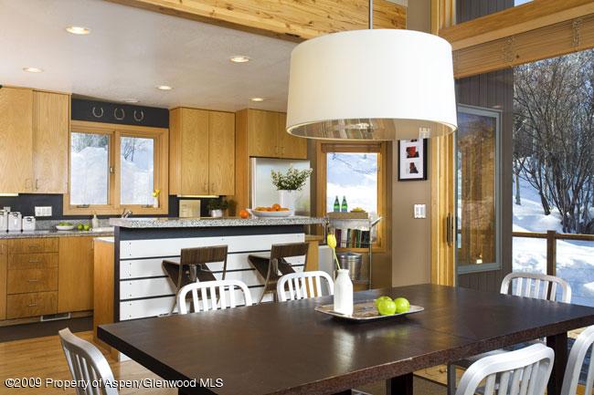 135 North Ridge Lane Snowmass Village, CO 81615 - Photo 8 of 8 a kitchen with a table chairs and a dining table