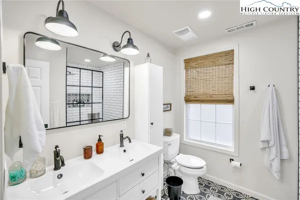 a bathroom with a sink toilet a mirror and tub