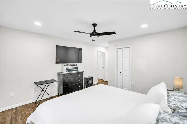 a bedroom with a bed and a flat screen tv