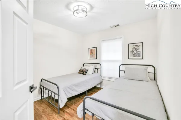 a bedroom with two beds and a table