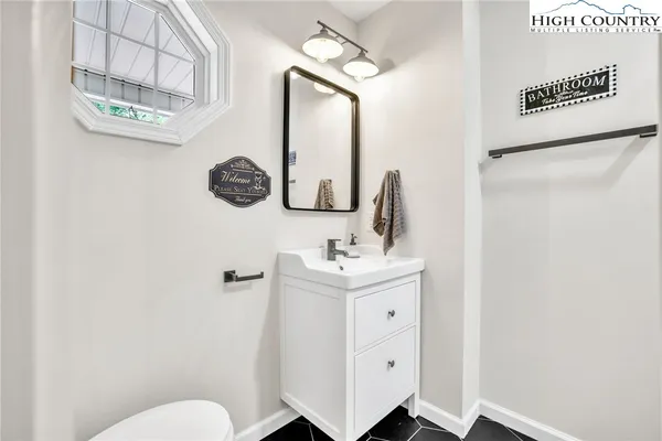 a bathroom with a toilet sink and mirror