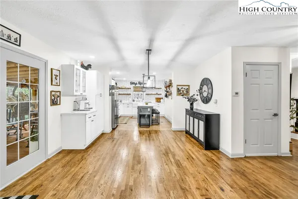 a view of a kitchen with sink and wooden floor